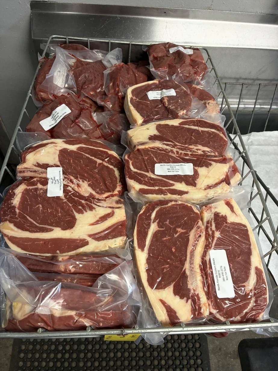 Fresh-cut steaks vacuum sealed and labeled at North Florida Custom Meats